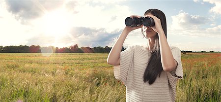 simsearch:400-04632747,k - Young woman watching with binocular Fotografie stock - Microstock e Abbonamento, Codice: 400-06853510