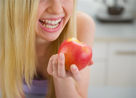Closeup on smiling teenager girl eating apple Stock Photo - Budget Royalty-Free & Subscription, Code: 400-06853615