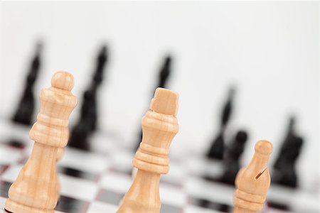 simsearch:640-03260640,k - Chess pieces standing at the chessboard against white background Stock Photo - Budget Royalty-Free & Subscription, Code: 400-06864253