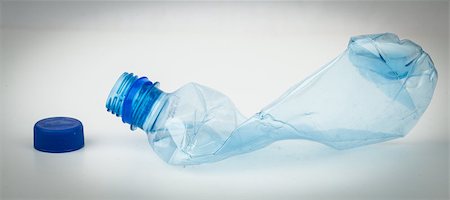simsearch:400-03928997,k - Empty plastic bottle crushed and blue cap for recycling Photographie de stock - Aubaine LD & Abonnement, Code: 400-06864358