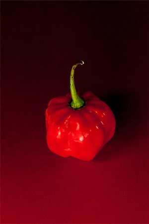 simsearch:400-06864396,k - Red scotch bonnet chili pepper on red and black background Stock Photo - Budget Royalty-Free & Subscription, Code: 400-06864392