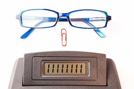 Sector of calculator display with blue glasses and red paper clip Stock Photo - Budget Royalty-Free & Subscription, Code: 400-06864439