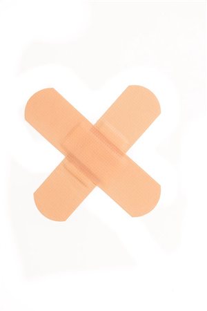 Two plasters crossed on white background Stock Photo - Budget Royalty-Free & Subscription, Code: 400-06864441