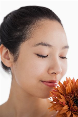 fresh-faced - Beautiful woman smelling a flower Stock Photo - Budget Royalty-Free & Subscription, Code: 400-06864597