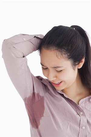 sweaty teen girl - Distressed woman looking at sweat patches Stock Photo - Budget Royalty-Free & Subscription, Code: 400-06864627