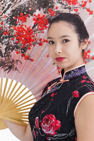 Woman wearing traditional Asian clothing with a large fan Stock Photo - Budget Royalty-Free & Subscription, Code: 400-06864659