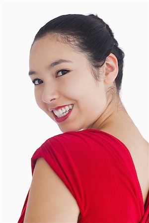 Smiling woman in red dress looking over her shoulder Stock Photo - Budget Royalty-Free & Subscription, Code: 400-06864689