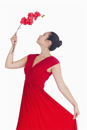 simsearch:400-07059876,k - Woman posing with orchid in red dress Foto de stock - Super Valor sin royalties y Suscripción, Código: 400-06864696