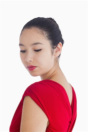Woman looking over her shoulder in red dress smiling gently Stock Photo - Budget Royalty-Free & Subscription, Code: 400-06864690