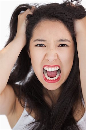person screaming pulling hair - Woman screaming and pulling her hair out on white background Stock Photo - Budget Royalty-Free & Subscription, Code: 400-06864739