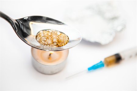 Heroin being cooked in a spoon over a tea light candle Stock Photo - Budget Royalty-Free & Subscription, Code: 400-06864755