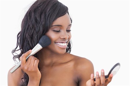 Smiling woman using makeup powder and brush Stock Photo - Budget Royalty-Free & Subscription, Code: 400-06865121