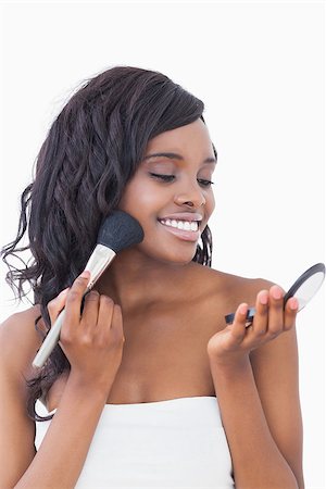 Woman happily putting on face powder Stock Photo - Budget Royalty-Free & Subscription, Code: 400-06865122