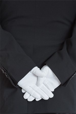 close-up rear side of a waiter wearing gloves with hands clasped Stock Photo - Budget Royalty-Free & Subscription, Code: 400-06865430