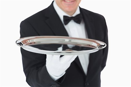 plateau d'argent - Smiling man holding a silver tray in front of camera Photographie de stock - Aubaine LD & Abonnement, Code: 400-06865474