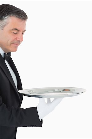 plateau d'argent - Waiter looking and holding a silver tray in front of camera Photographie de stock - Aubaine LD & Abonnement, Code: 400-06865489