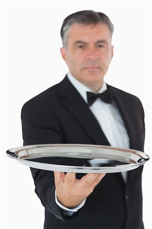 Serious waiter holding silver tray Fotografie stock - Microstock e Abbonamento, Codice: 400-06865482