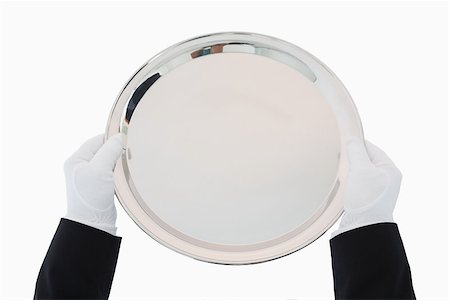 Silver tray being held out by man in suit and gloves Fotografie stock - Microstock e Abbonamento, Codice: 400-06865499