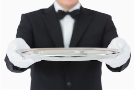 Waiter holding a silver tray with both hands on white background Fotografie stock - Microstock e Abbonamento, Codice: 400-06865493