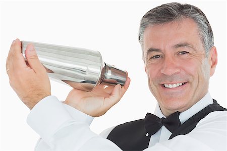 simsearch:6109-07601183,k - Happy waiter in suit shaking drink in cocktail shaker on white background Foto de stock - Super Valor sin royalties y Suscripción, Código: 400-06865578