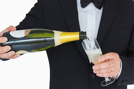 Well-dressed man pouring champagne into flute Stock Photo - Budget Royalty-Free & Subscription, Code: 400-06865627