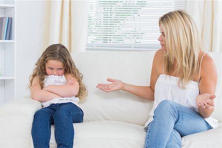 Angry mother sitting with her daughter on the sofa in the living room Stock Photo - Budget Royalty-Free & Subscription, Code: 400-06865884