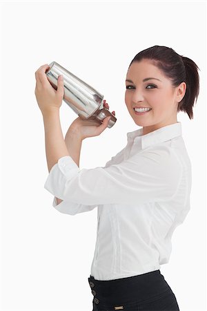 drink shaker - Smiling woman shaking cocktail in cocktail shaker Stock Photo - Budget Royalty-Free & Subscription, Code: 400-06865880