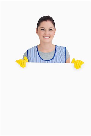 simsearch:400-06866097,k - Cleaning woman showing a white panel on the white background Foto de stock - Super Valor sin royalties y Suscripción, Código: 400-06866024