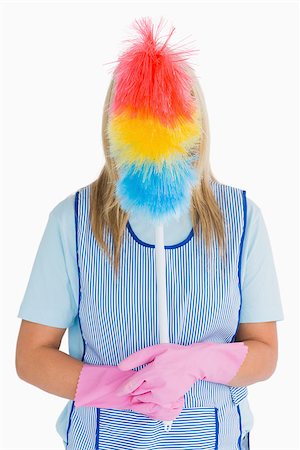 simsearch:400-06866097,k - Cleaner holding a feather duster in front her face in the white background Foto de stock - Super Valor sin royalties y Suscripción, Código: 400-06866108