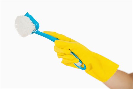 Female hand in rubber gloves holding blue scrubbing brush Foto de stock - Super Valor sin royalties y Suscripción, Código: 400-06866364