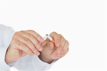 Male hands breaking a cigarette in half Stock Photo - Budget Royalty-Free & Subscription, Code: 400-06866386