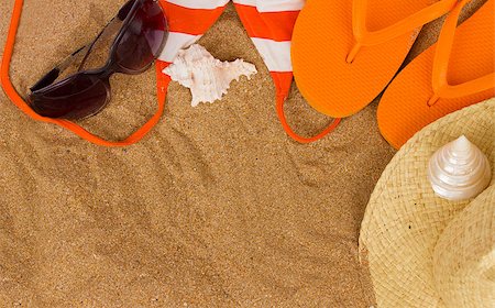 orange sandals  and sunbathing accessories at sand with copy space Stock Photo - Budget Royalty-Free & Subscription, Code: 400-06867635