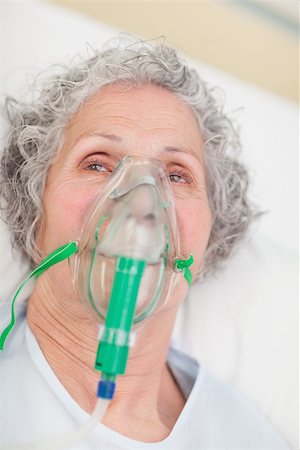 elderly woman on oxygen mask - Elderly woman with an oxygen mask in a hospital looking away Stock Photo - Budget Royalty-Free & Subscription, Code: 400-06867979