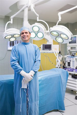 Smiling surgeon posing in an operation theater Stock Photo - Budget Royalty-Free & Subscription, Code: 400-06868015