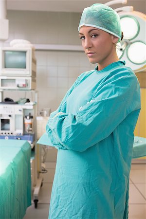 Female surgeon crossing her arms while standing next to an operating table in a hospital Stock Photo - Budget Royalty-Free & Subscription, Code: 400-06868024