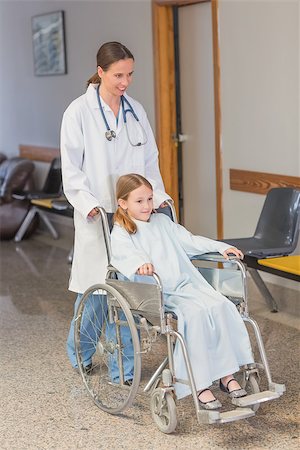 paraplegic women in wheelchairs - Doctor wheeling a patient in a wheelchair in a hospital hallway Stock Photo - Budget Royalty-Free & Subscription, Code: 400-06868068