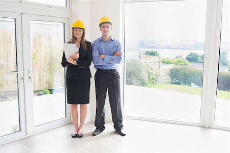 simsearch:400-07475963,k - Estate agent and client wearing hardhats standing in house Stock Photo - Budget Royalty-Free & Subscription, Code: 400-06868122