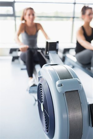 simsearch:400-06801591,k - Rowing machine being used by woman in gym Stock Photo - Budget Royalty-Free & Subscription, Code: 400-06868157