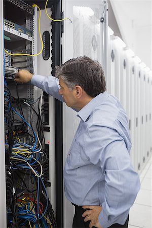 simsearch:693-03304665,k - Technician controlling the server case and adjusting the cables Stock Photo - Budget Royalty-Free & Subscription, Code: 400-06868363