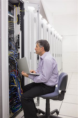 server tower - Technician holding a laptop to check the server operations Stock Photo - Budget Royalty-Free & Subscription, Code: 400-06868377