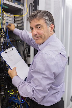 server tower - Data center worker checking the servers and holding clipboard Stock Photo - Budget Royalty-Free & Subscription, Code: 400-06868383