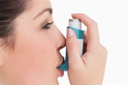 photo inhaler person - Woman with an asthma inhaler against white background Stock Photo - Budget Royalty-Free & Subscription, Code: 400-06868440
