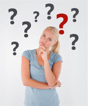 Blonde woman thinking on white background with question marks Stock Photo - Budget Royalty-Free & Subscription, Code: 400-06868469