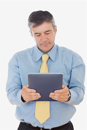 simsearch:400-07230809,k - Mature businessman using digital tablet over white background Foto de stock - Super Valor sin royalties y Suscripción, Código: 400-06868517