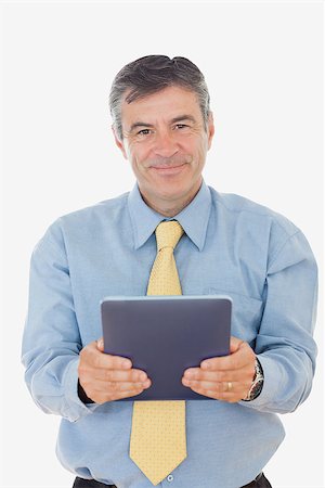 simsearch:400-07230809,k - Portrait of mature businessman holding digital tablet against white background Foto de stock - Super Valor sin royalties y Suscripción, Código: 400-06868518