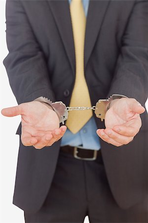 simsearch:400-06868565,k - Handcuffed businessman standing over white background Photographie de stock - Aubaine LD & Abonnement, Code: 400-06868544