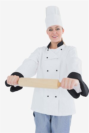 rolling over - Happy woman in chef clothing holding rolling pin isolated over white background Foto de stock - Super Valor sin royalties y Suscripción, Código: 400-06868614