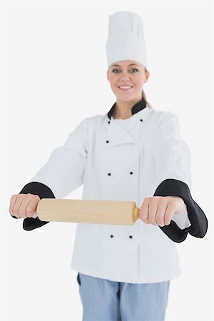 rolling over - Portrait of happy woman in chef clothing holding rolling pin isolated over white background Foto de stock - Super Valor sin royalties y Suscripción, Código: 400-06868615