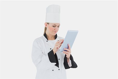 Female chef using tablet computer over white background Stock Photo - Budget Royalty-Free & Subscription, Code: 400-06868680