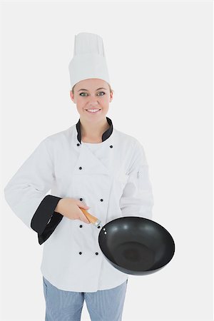 simsearch:400-07953213,k - Portrait of happy female chef holding empty frying pan over white background Foto de stock - Super Valor sin royalties y Suscripción, Código: 400-06868714